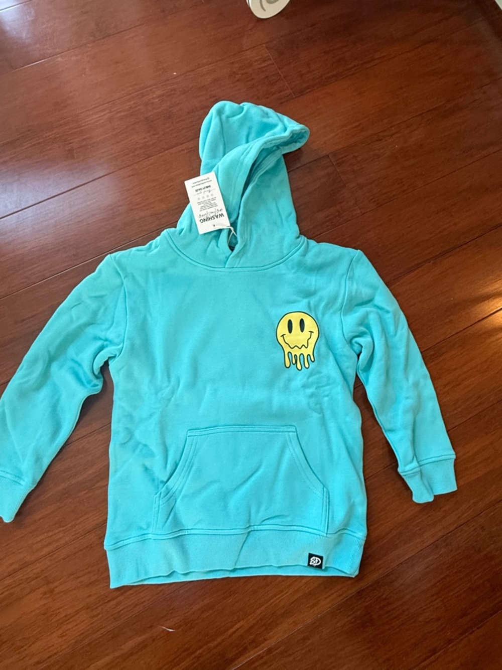 Turquoise Hoodie with Yellow Dripping Smile Patch